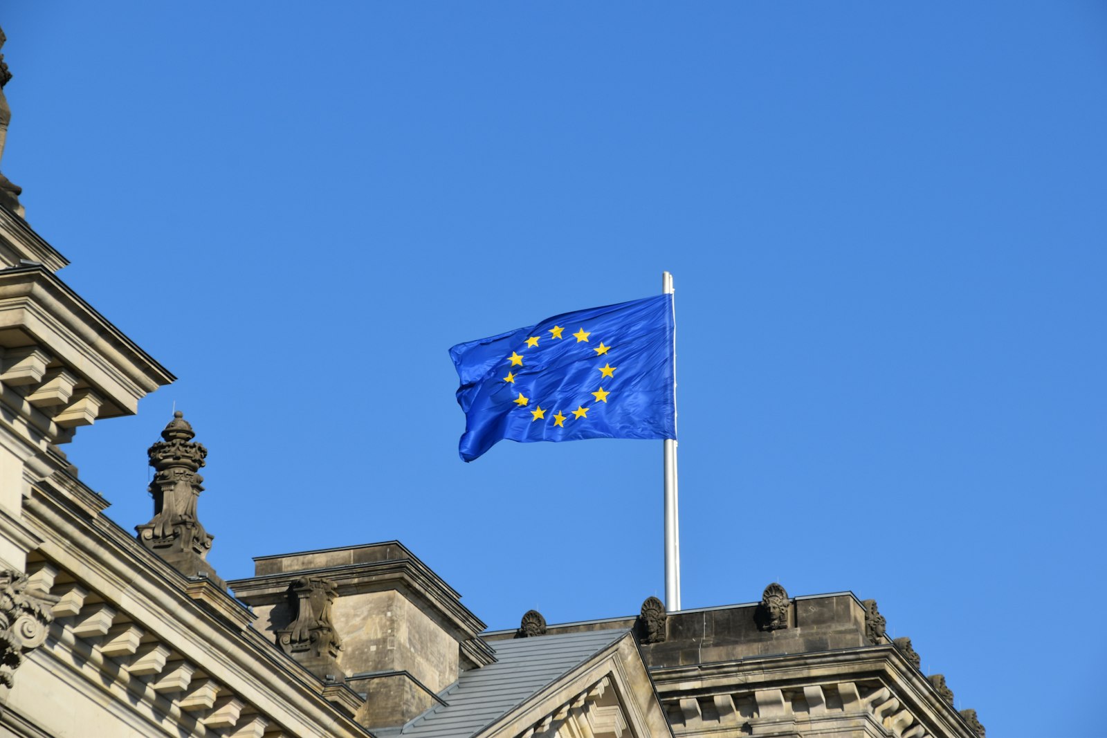 European Union flag above a historic building